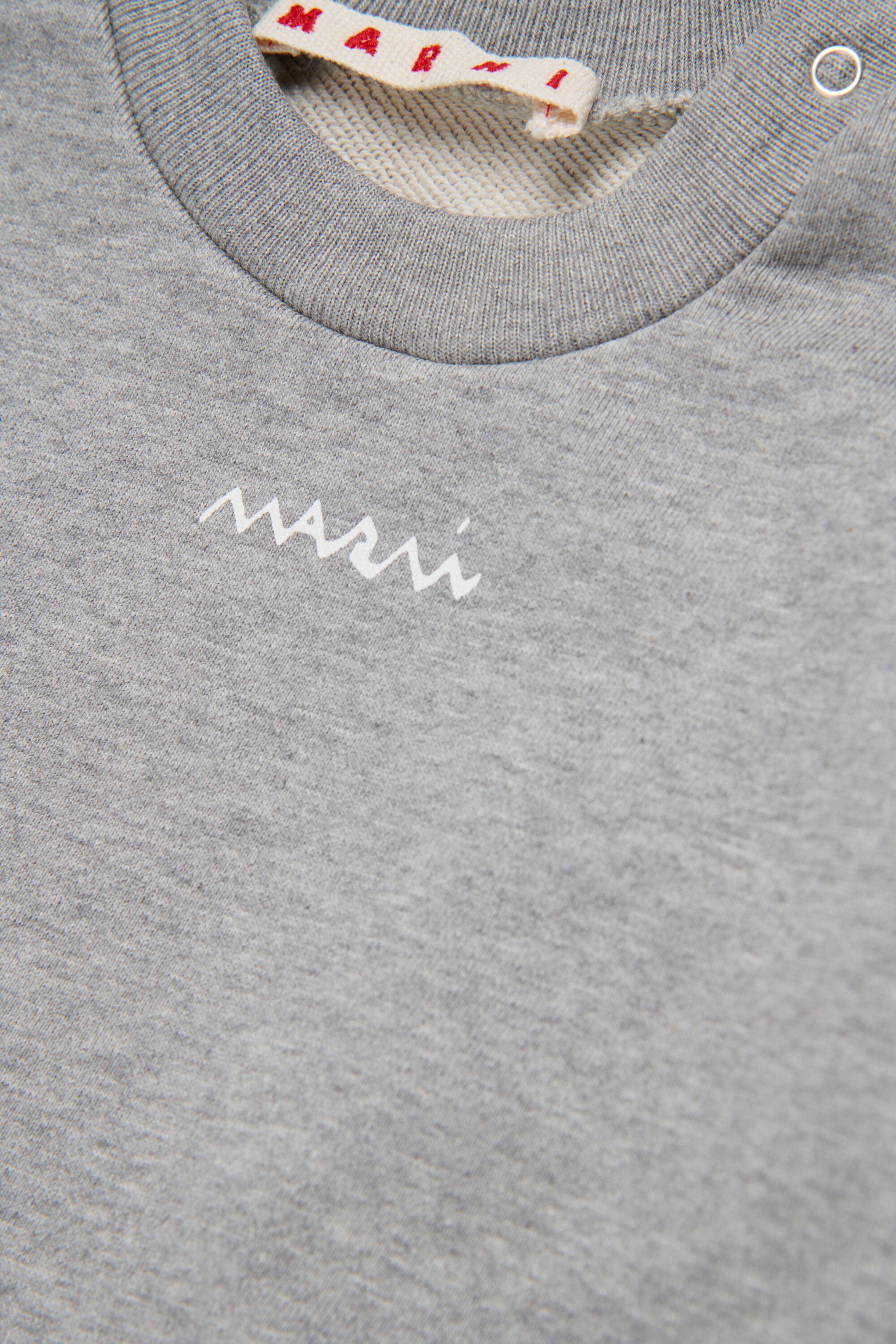 裾にフラウンスが付いたクルーネックのスウェットシャツ