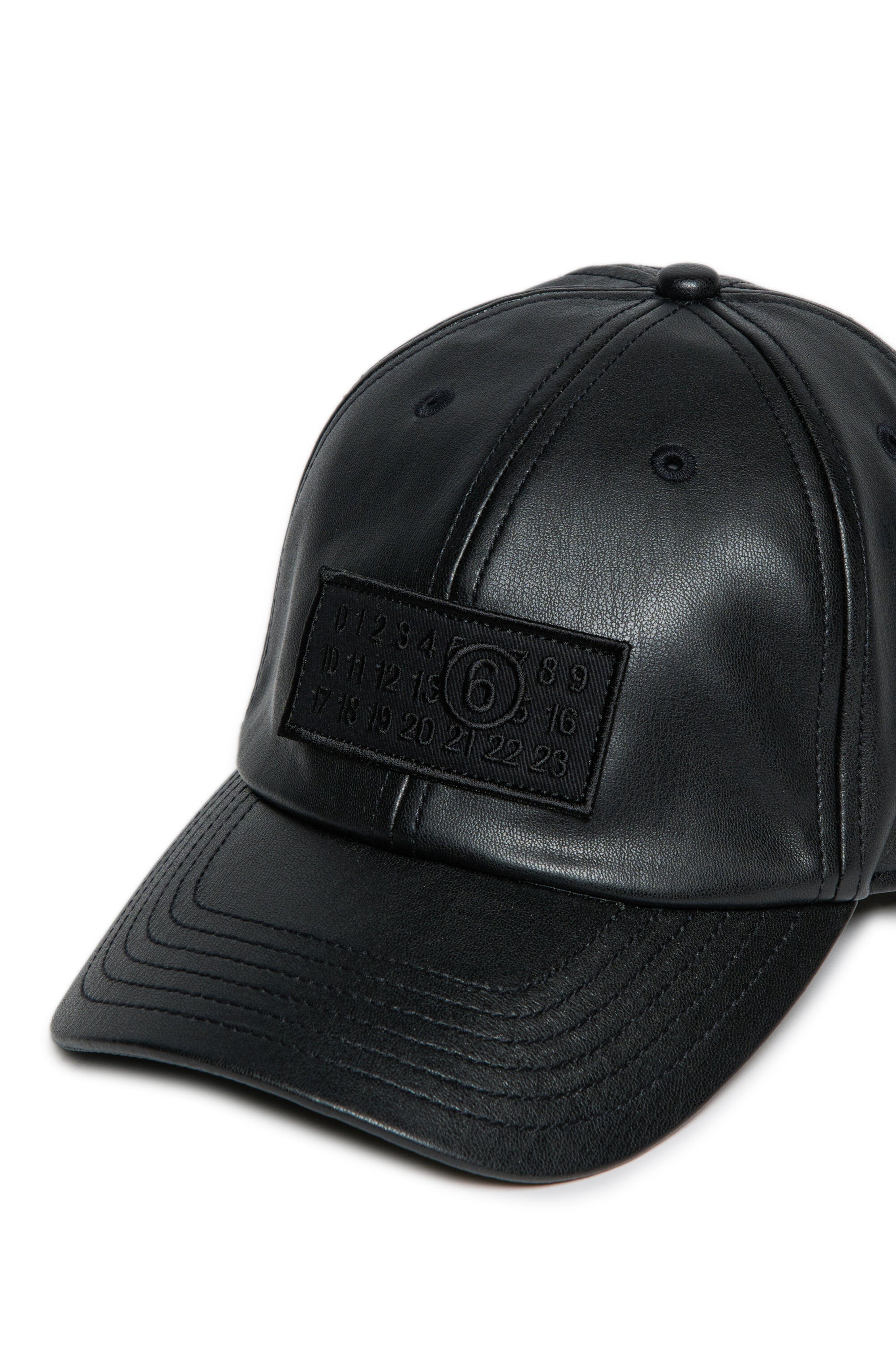 Baseball cap in coated fabric with patch